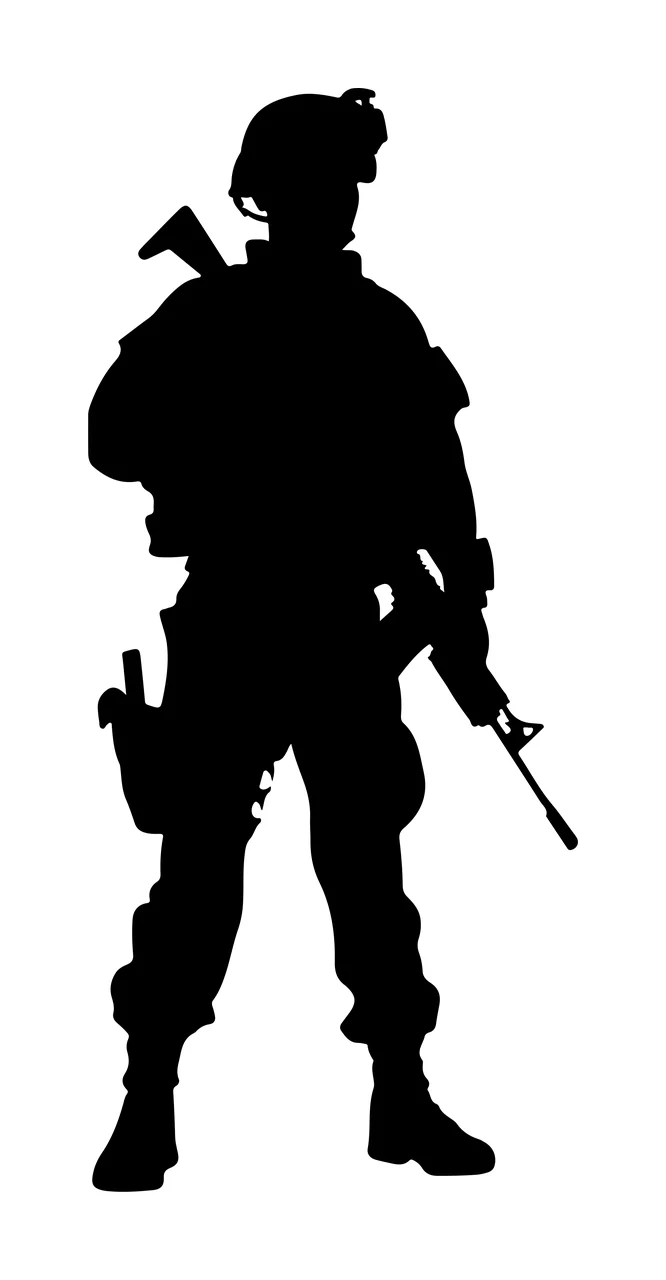 Silhouette Of An Armed Individual In Tactical Gear standing